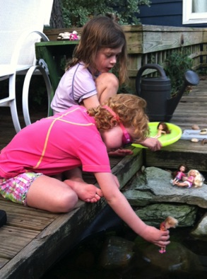Kids playing at the edge of
our pond Kids playing at the edge of
our pond